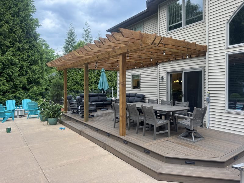 Deck with wood pergola and outdoor patio dining area, natural gray-brown stain finish by TD Surface Stain and Seal