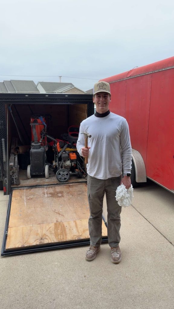 Trystin Decatoire, owner of TD Surface Stain and Seal, at the TD Surface trailer